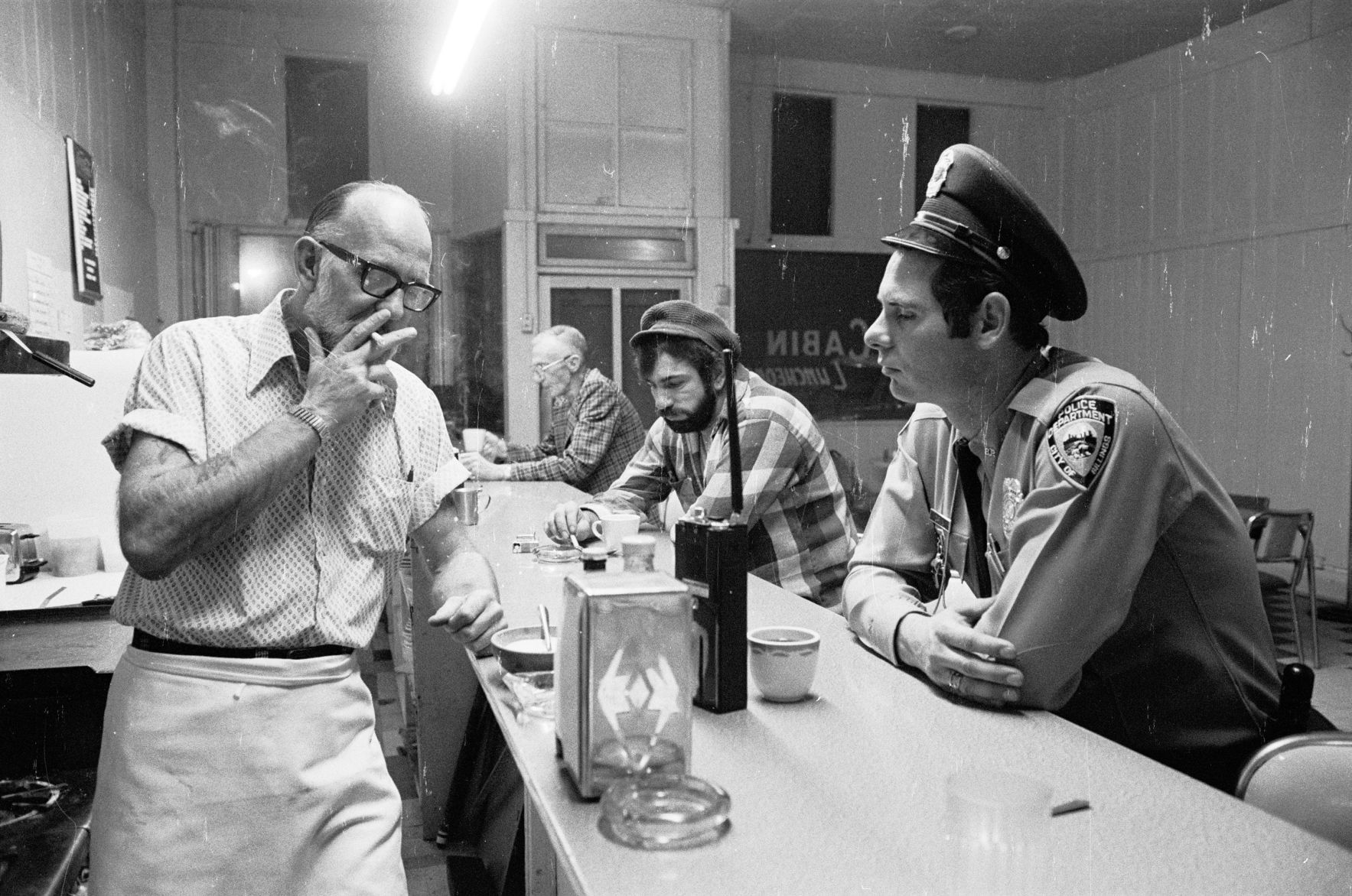 Officer Bill Garvin at the Log Cabin Cafe, 1975